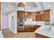 Bright kitchen with stainless steel appliances, white countertops and dark-stained cabinets at 140 Riviera Dunes Way # 1203, Palmetto, FL 34221