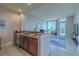 A well-appointed kitchenette and living room feature modern appliances and tile flooring at 140 Riviera Dunes Way # 1203, Palmetto, FL 34221