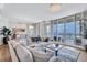 Inviting living room with comfortable sofa, area rug, stylish furniture and a beautiful water view at 140 Riviera Dunes Way # 1203, Palmetto, FL 34221