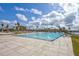 Large community swimming pool featuring fountains, palm trees and a blue sky at 140 Riviera Dunes Way # 1203, Palmetto, FL 34221