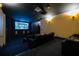 Home theater with leather seating, projector screen, and ambient lighting at 140 Riviera Dunes Way # 1203, Palmetto, FL 34221