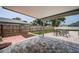 View of backyard, including patio with furniture and grass yard with fence at 1402 Oleander Dr, Tarpon Springs, FL 34689