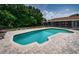 Aerial view of the backyard pool and patio, showing covered deck on house at 1402 Oleander Dr, Tarpon Springs, FL 34689