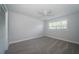 Cozy bedroom featuring soft carpeting, neutral walls, and ample natural light at 1402 Oleander Dr, Tarpon Springs, FL 34689