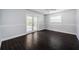 Inviting bedroom with private patio, wood-look floors, and neutral decor, providing a cozy retreat at 1402 Oleander Dr, Tarpon Springs, FL 34689