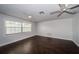 Bright bedroom with hardwood floors, a large window, and a ceiling fan at 1402 Oleander Dr, Tarpon Springs, FL 34689
