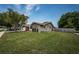 Charming single-story home with well-manicured lawn and landscaping at 1402 Oleander Dr, Tarpon Springs, FL 34689