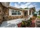 Inviting front porch with stone facade, manicured landscaping, and white trim at 1402 Oleander Dr, Tarpon Springs, FL 34689