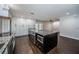 Open kitchen with a large center island, granite counters, and stainless steel appliances at 1402 Oleander Dr, Tarpon Springs, FL 34689