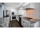 Updated kitchen featuring stainless steel appliances and granite countertops at 1402 Oleander Dr, Tarpon Springs, FL 34689