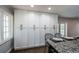 Kitchen featuring ample storage with floor-to-ceiling cabinets and granite countertops at 1402 Oleander Dr, Tarpon Springs, FL 34689