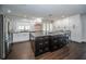 Spacious kitchen featuring granite countertops, stainless steel appliances, and dark wood flooring at 1402 Oleander Dr, Tarpon Springs, FL 34689