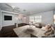Bright living room with wood-look floors, neutral walls, and three ceiling fans at 1402 Oleander Dr, Tarpon Springs, FL 34689