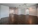 Spacious living room featuring hardwood floors and a partially open floor plan at 1402 Oleander Dr, Tarpon Springs, FL 34689
