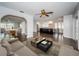 Spacious living room with dark wood-look floors and an open layout flowing into the kitchen and dining area at 1402 Oleander Dr, Tarpon Springs, FL 34689