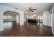 Spacious living room with dark wood-look floors and an open layout flowing into the kitchen and dining area at 1402 Oleander Dr, Tarpon Springs, FL 34689