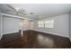Spacious living room featuring wood-look floors, neutral walls, and three ceiling fans at 1402 Oleander Dr, Tarpon Springs, FL 34689