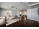 Open-concept living room with hardwood floors and bright, neutral decor at 1402 Oleander Dr, Tarpon Springs, FL 34689