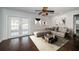 Bright living room with a neutral color palette, tile flooring and access to a screened pool at 1402 Oleander Dr, Tarpon Springs, FL 34689