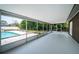 Expansive screened patio providing a view of the pool and landscaped backyard at 1402 Oleander Dr, Tarpon Springs, FL 34689