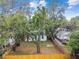 An aerial view of the backyard featuring mature trees and a privacy fence at 1404 E Curtis St, Tampa, FL 33603