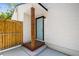 Back door of home with light-colored wood siding and door, with access to the fenced backyard and outdoor space at 1404 E Curtis St, Tampa, FL 33603