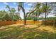 Large backyard featuring a privacy fence, mature trees, and plenty of shade at 1404 E Curtis St, Tampa, FL 33603
