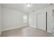 Bright bedroom with wood-look floors and sliding door closet providing storage in a light-filled, tranquil space at 1404 E Curtis St, Tampa, FL 33603