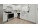 Modern kitchen featuring white cabinets, stainless steel appliances, and a bright, clean design at 1404 E Curtis St, Tampa, FL 33603