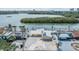 Waterfront property with a boat lift, metal roof, solar panels, and a wide paved driveway at 1421 Sea Gull S Dr, St Petersburg, FL 33707