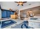 Entertainment room featuring a built-in bar, ceiling fans, and access to other rooms at 1421 Sea Gull S Dr, St Petersburg, FL 33707