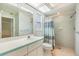 Bathroom features vanity, toilet and shower with a window, tile walls and modern lighting at 1421 Sea Gull S Dr, St Petersburg, FL 33707