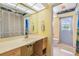 Bright bathroom with large vanity, nautical-themed decor, offering functionality and vintage design at 1421 Sea Gull S Dr, St Petersburg, FL 33707