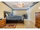 Well-lit bedroom featuring a bed, desk, and dark wood furniture at 1421 Sea Gull S Dr, St Petersburg, FL 33707