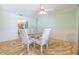 Dining room features a glass table, four upholstered chairs, and an interesting floor at 1421 Sea Gull S Dr, St Petersburg, FL 33707