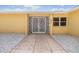 Elegant white decorative security door with stone path, white rock landscaping, and yellow exterior at 1421 Sea Gull S Dr, St Petersburg, FL 33707