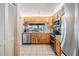 Kitchen features stainless appliances, light wood cabinets, neutral counters, and an open view at 1421 Sea Gull S Dr, St Petersburg, FL 33707