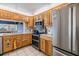 Kitchen features stainless appliances, light wood cabinets, neutral counters, and an open view at 1421 Sea Gull S Dr, St Petersburg, FL 33707