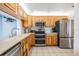 Well-lit kitchen with stainless appliances, light wood cabinets, and neutral countertops at 1421 Sea Gull S Dr, St Petersburg, FL 33707
