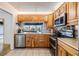 Kitchen features stainless appliances, light wood cabinets, neutral counters, and an open view at 1421 Sea Gull S Dr, St Petersburg, FL 33707