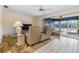 Living room featuring tile floors, a ceiling fan, recliners, and views of the waterfront at 1421 Sea Gull S Dr, St Petersburg, FL 33707