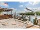 Waterfront view of boat lift, covered deck, boat, and dock at 1421 Sea Gull S Dr, St Petersburg, FL 33707