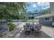 Outdoor patio with a grill, dining set, lush greenery and a stunning pool at 14626 Wildwood Dr, Largo, FL 33774
