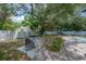 Beautiful backyard with a grill, mature landscaping, hammock and a refreshing pool at 14626 Wildwood Dr, Largo, FL 33774