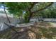 Secluded backyard features a hammock and mature landscaping, perfect for relaxation at 14626 Wildwood Dr, Largo, FL 33774