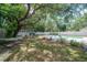 Expansive backyard with a hammock, swing, lush lawn and an inviting pool at 14626 Wildwood Dr, Largo, FL 33774
