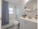 Bathroom featuring a shower and tub, sink, and decorative wall paper at 14626 Wildwood Dr, Largo, FL 33774
