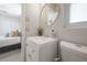 Contemporary bathroom with white vanity, round mirror, and a view to the bedroom at 14626 Wildwood Dr, Largo, FL 33774