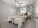 Bright bedroom with a ceiling fan, patterned accent wall, and cozy decor at 14626 Wildwood Dr, Largo, FL 33774