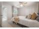 Sunny bedroom with patterned accent wall, plush bedding, and ample natural light at 14626 Wildwood Dr, Largo, FL 33774